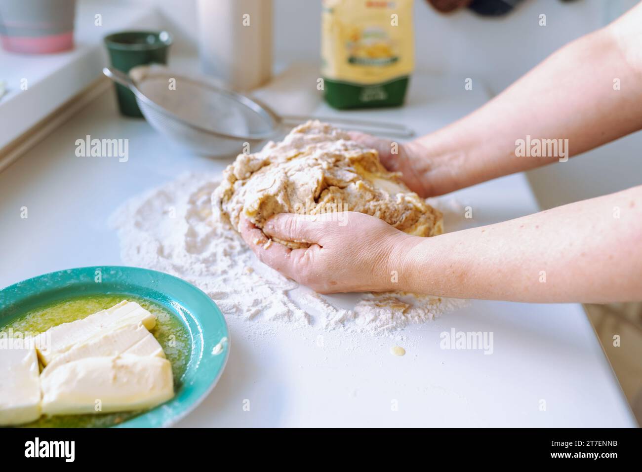 Female hands kneading dough Stock Photo