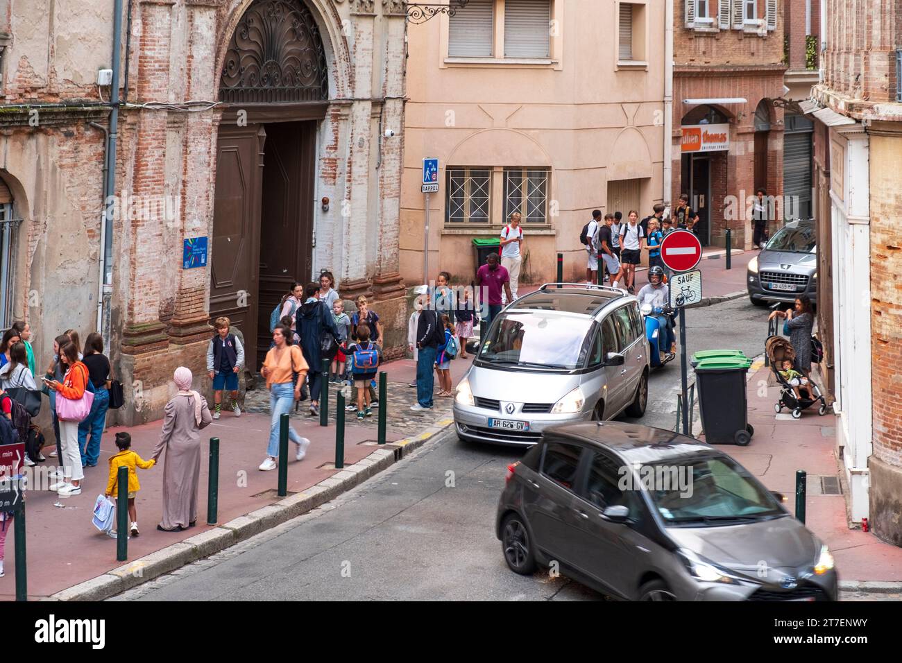 Children and Teens being dropped off outside of school, Toulouse, France Stock Photo