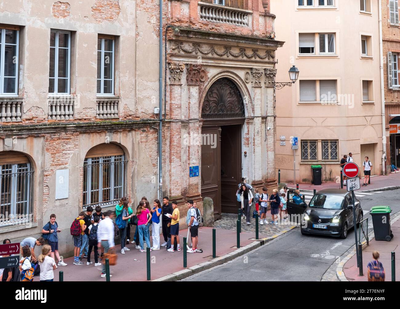 Children and Teens being dropped off outside of school, Toulouse, France Stock Photo