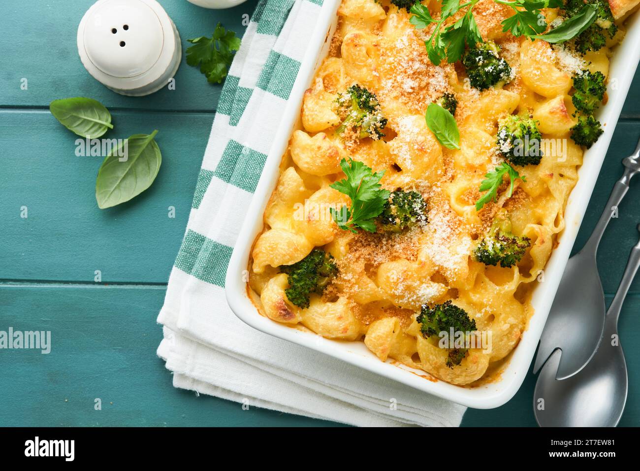 Pasta Broccoli casserole. Baked Mac and cheese with broccoli, cream sauce and parmesan on old rustic wooden background. Healthy or baby food. American Stock Photo