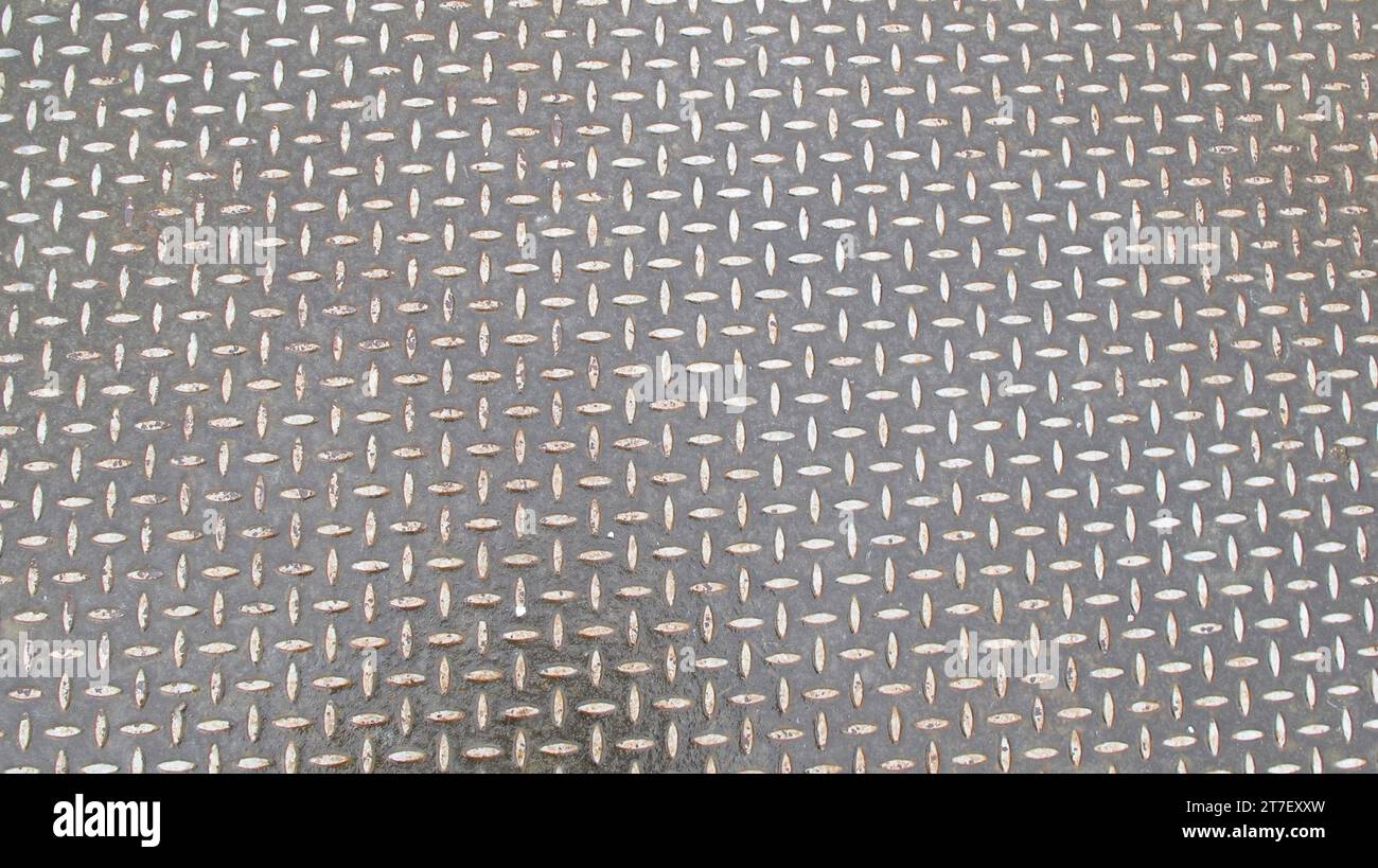 detail shot of a metallic drainage grate cover Stock Photo