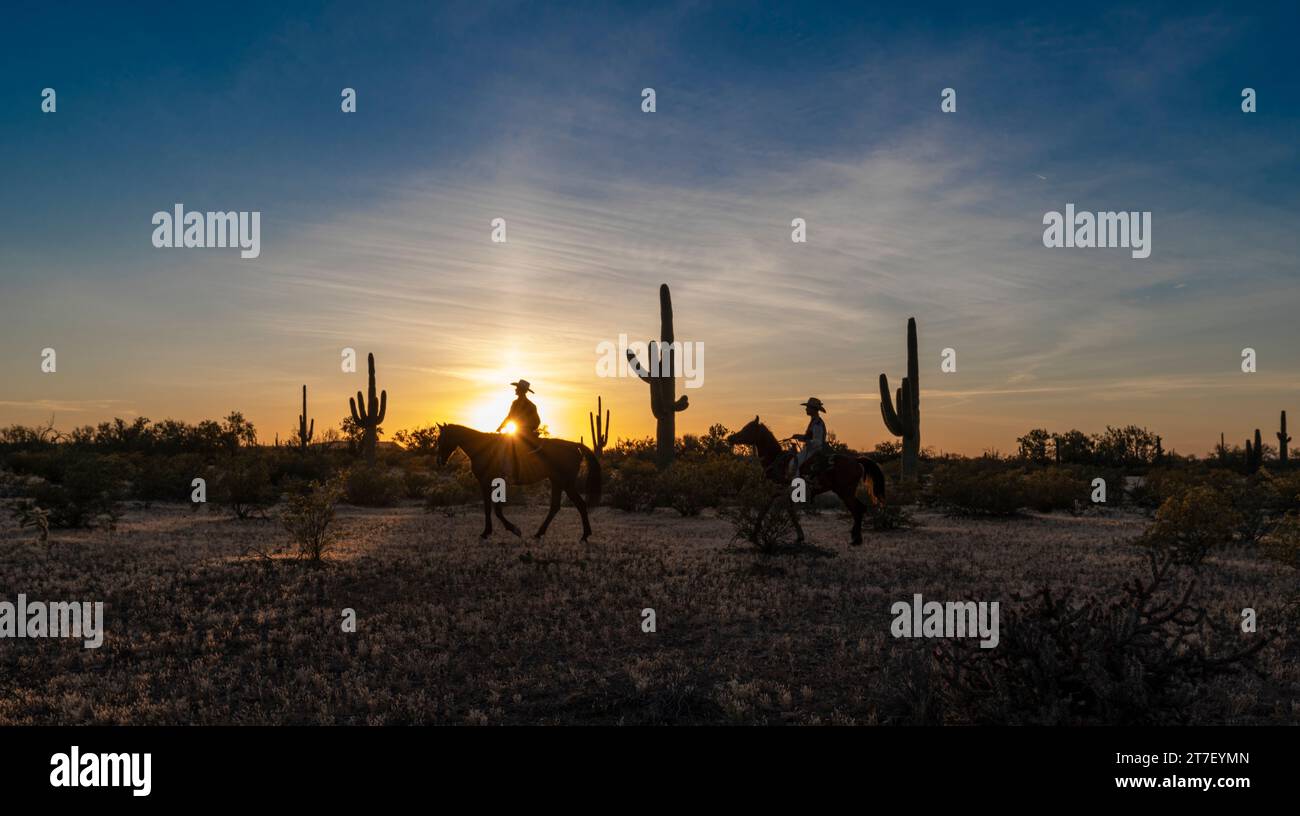 Hunter Cooley and Zach Libby ride at sunset, White Stallion guest ranch, Marana, Arizona Stock Photo