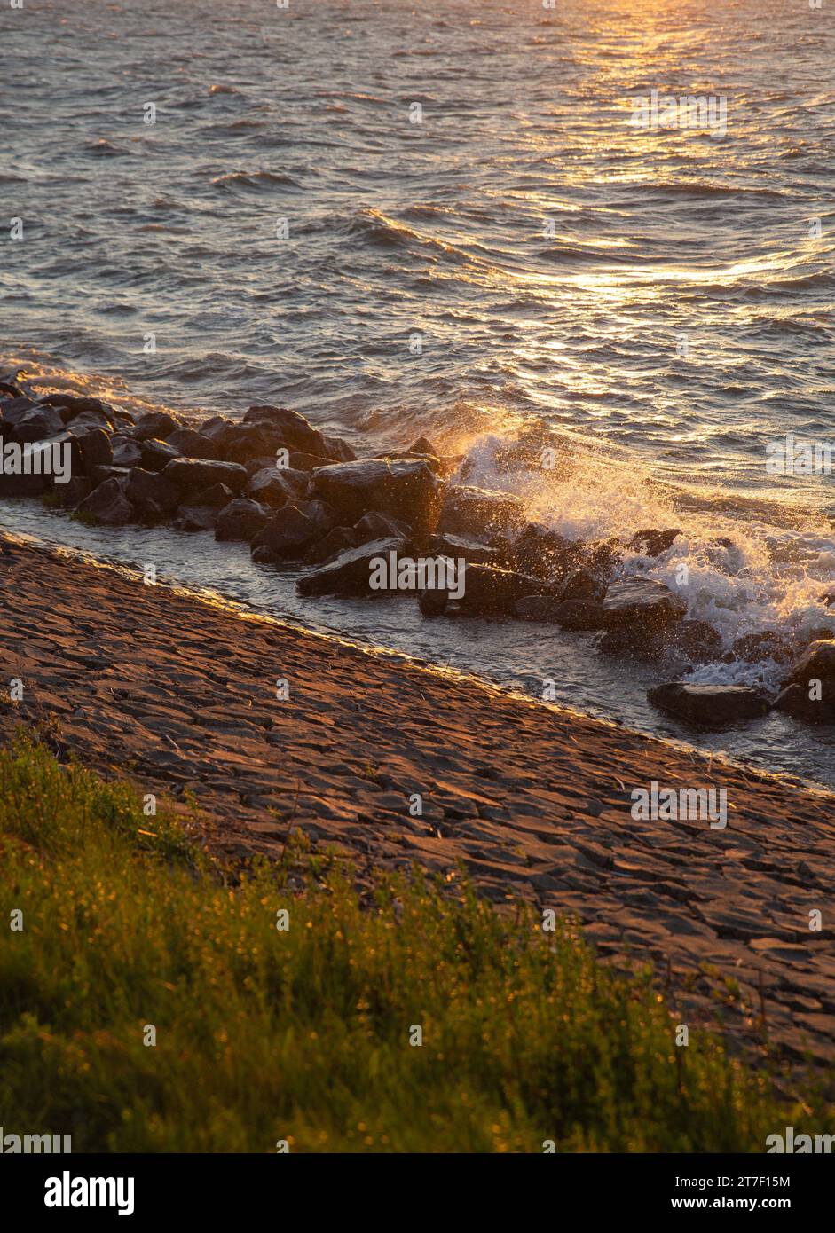 Sea sunset with waves hitting the seashore Stock Photo - Alamy
