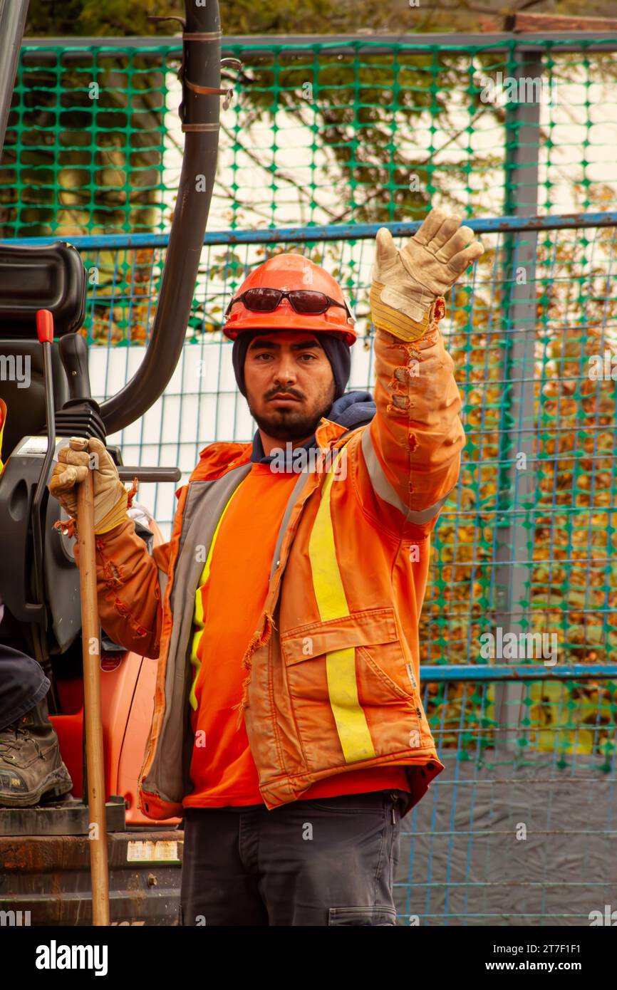 Construction worker waving Stock Photo - Alamy