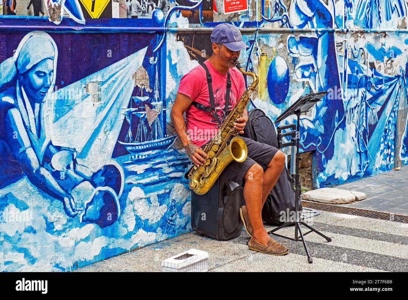 Busker playing saxophone in front of mural in the city centre of capital Montevideo, Uruguay, South America Stock Photo