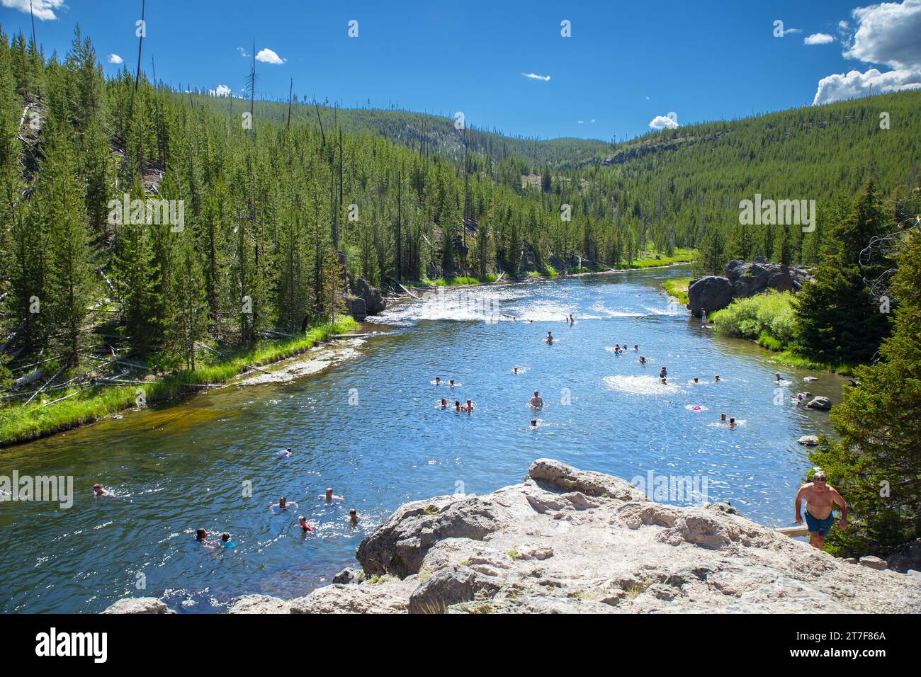 Yellowstone, America–June 12,2016:tourists swimming in hot-spring Stock Photo
