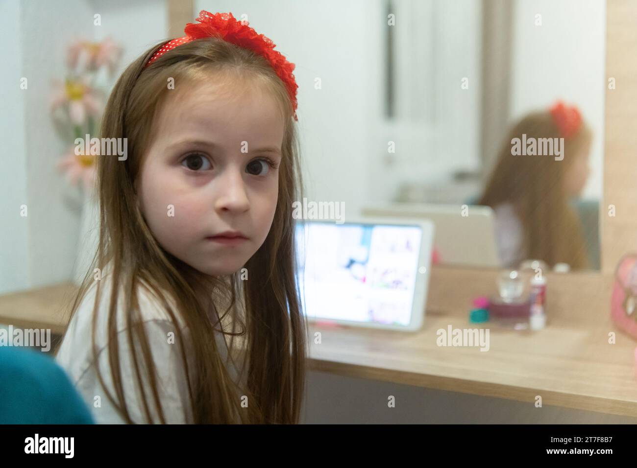 Little girl using her laptop in her room Stock Photo