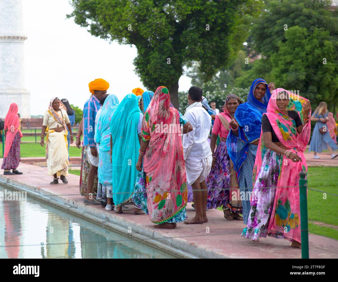 Taj Mahal, India–July 03,2019:A group of Indian tourists wearing colorful sari Stock Photo