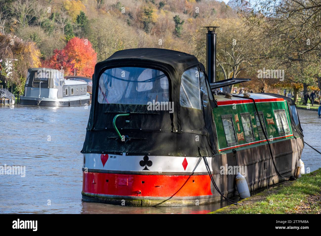 Canal boats moored along  The River Thames on visitor moorings adjacient to Mill Meadows , conveniently near the town centre of Henley on Thames Stock Photo