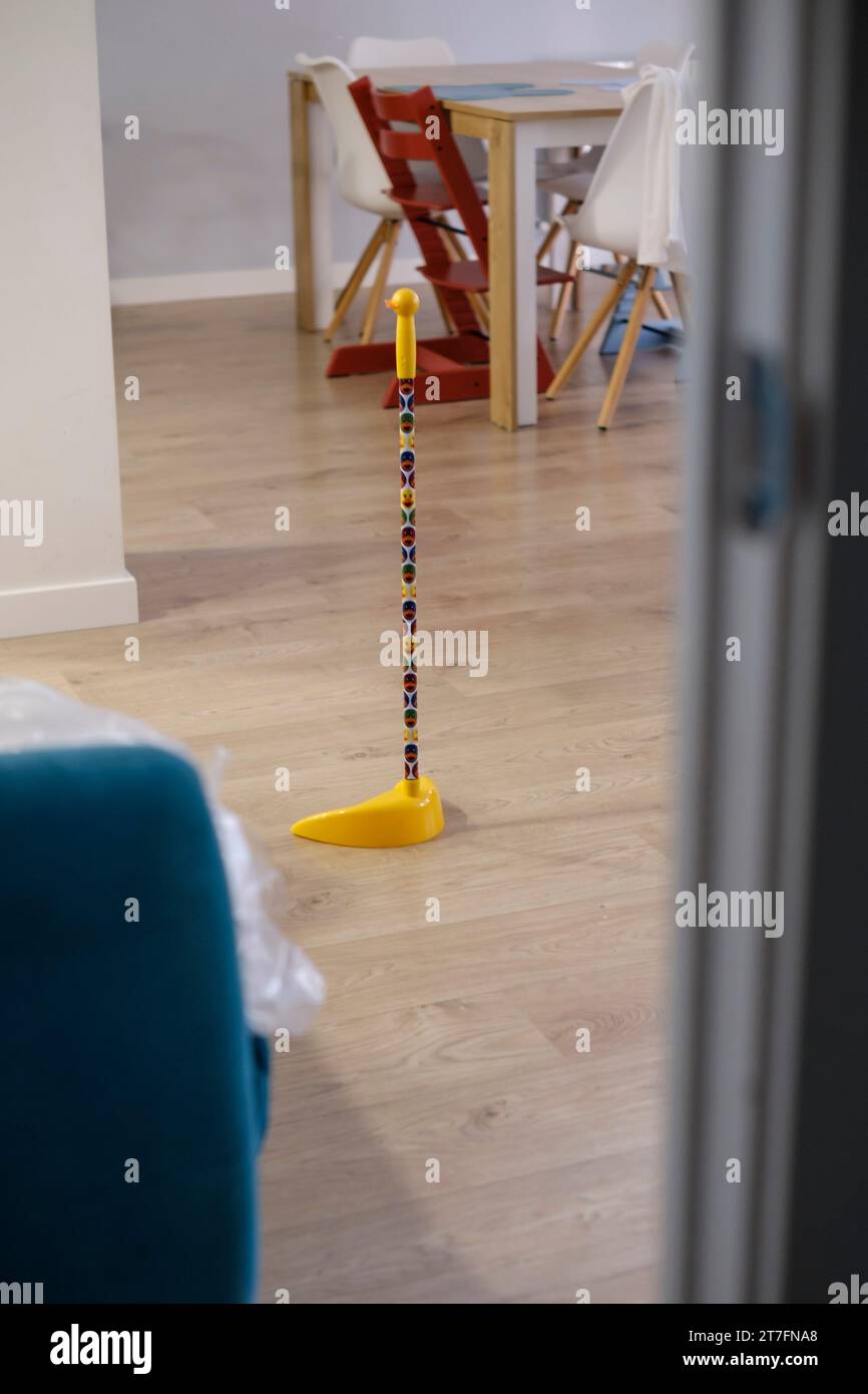 Plastic toy for cleaning home floor in a domestic interior scene with hardwood floor Stock Photo