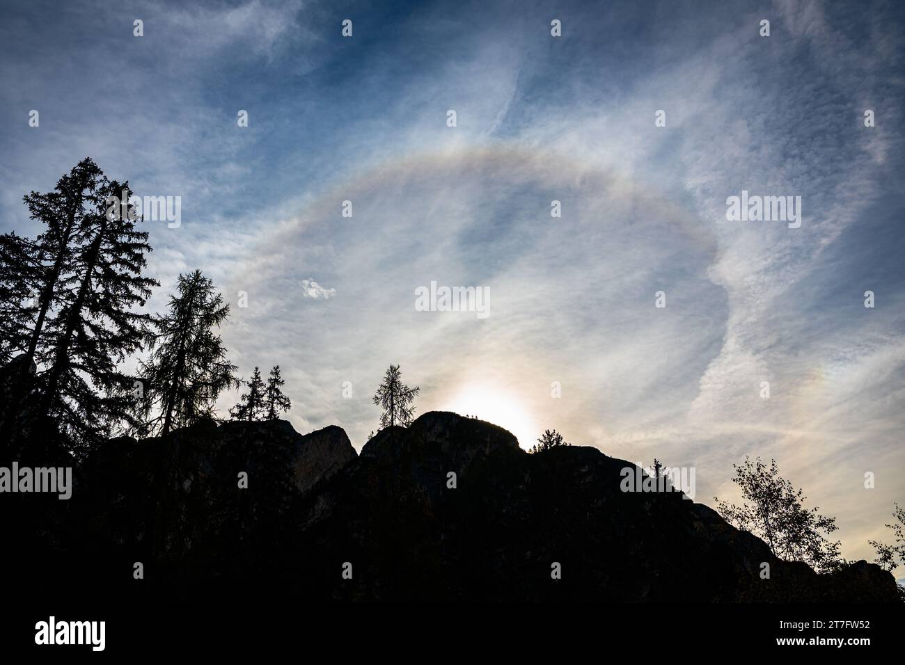 Bright colorful 22 degrees halo over a mountain. Stock Photo