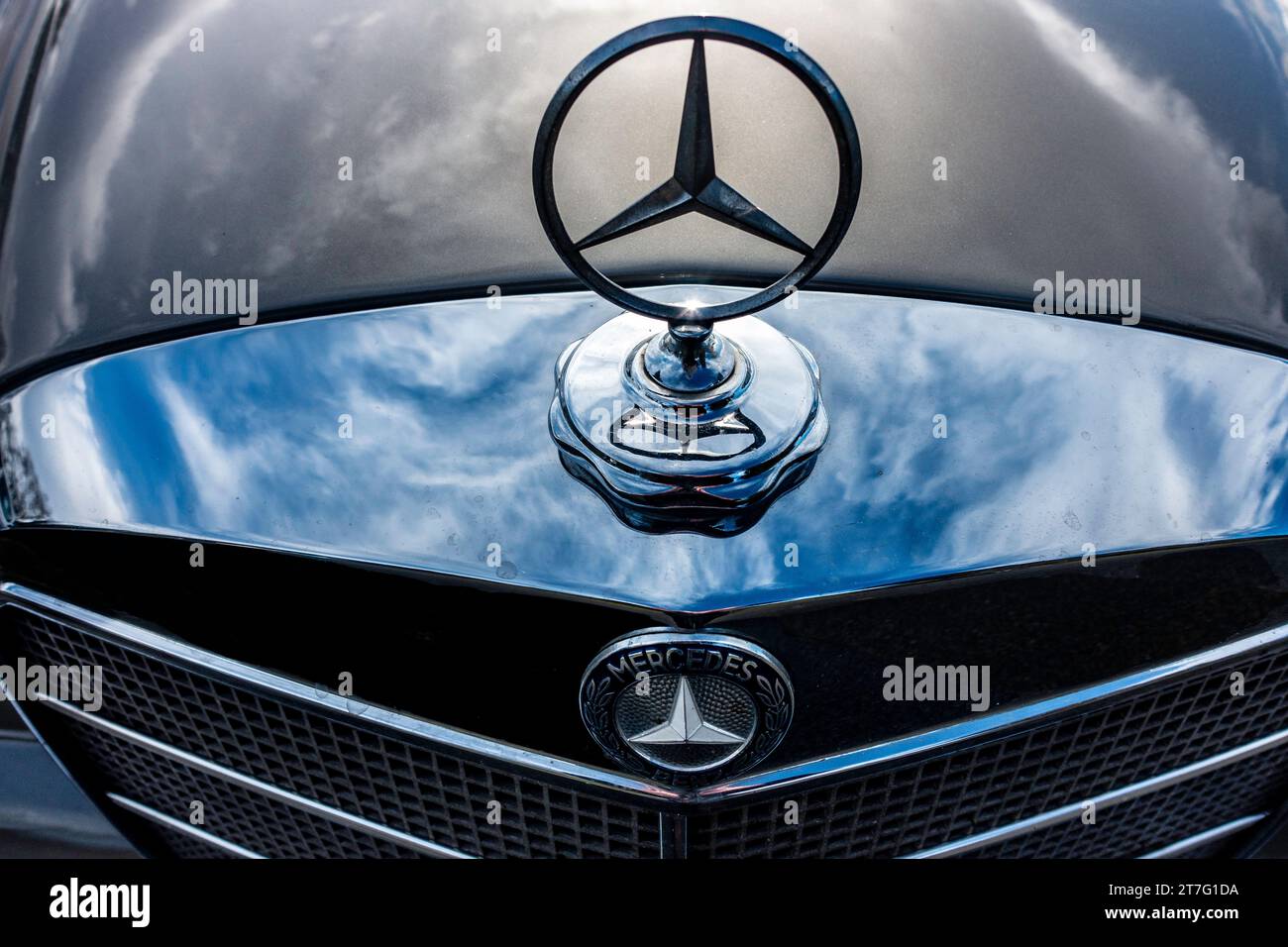 Close-up of a vintage Merceds car's hood, emblem, and grill. Stock Photo