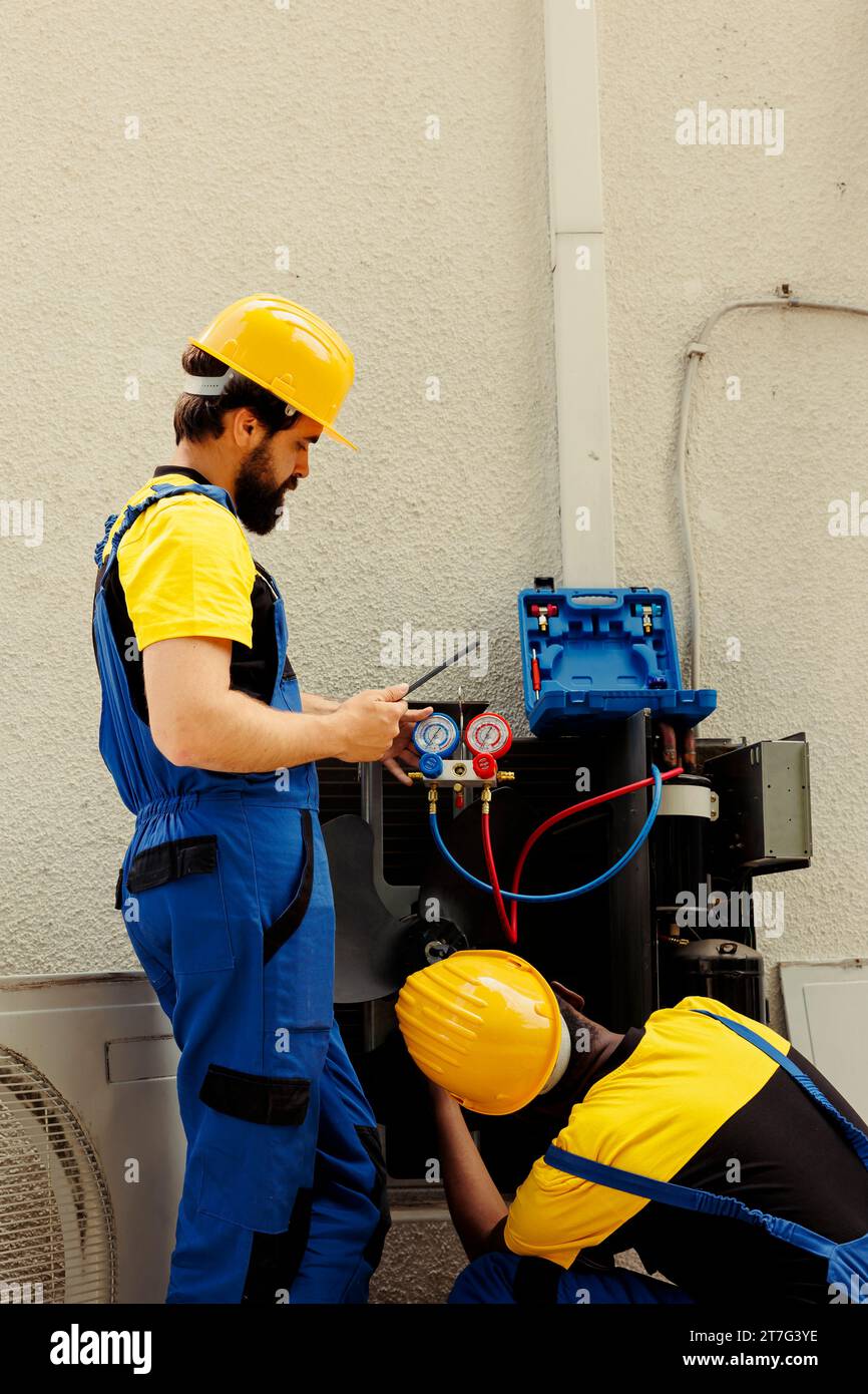 Competent mechanics fixing faulty blower fan causing frozen evaporator