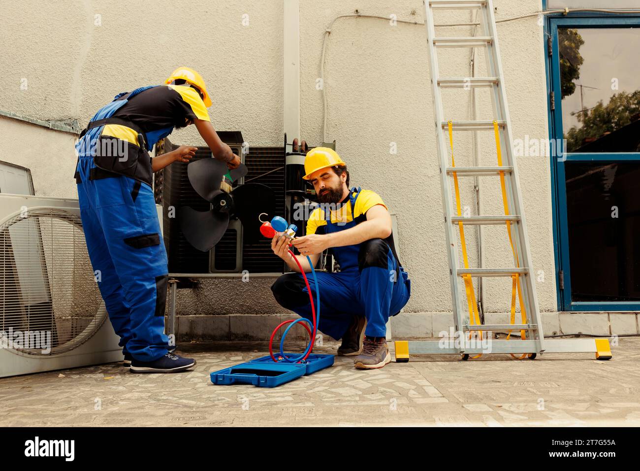 Engineer removing dirt and dust from air conditioner evaporator and condenser coils while