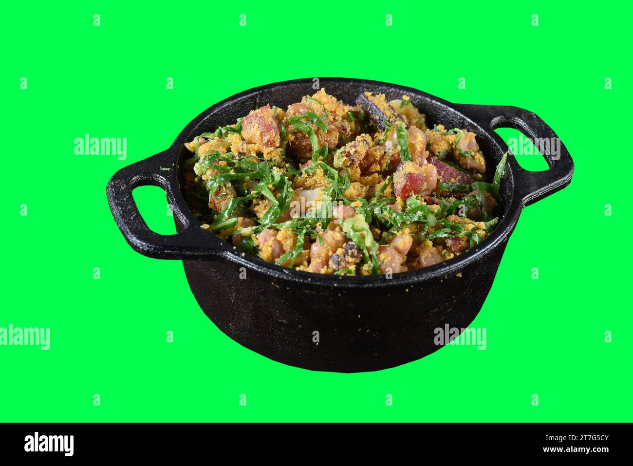 tropeiro beans with flour bacon cabbage sausage calabresa in iron pan typical brazilian food isolated on green background chroma key Stock Photo