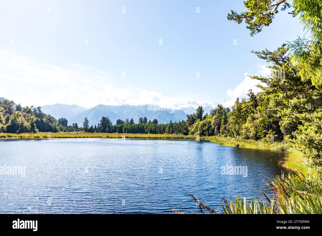 Lake Matheson is a small glacial lake in South Westland, New Zealand, near the township of Fox Glacier. It was a traditional food-gathering place for Stock Photo