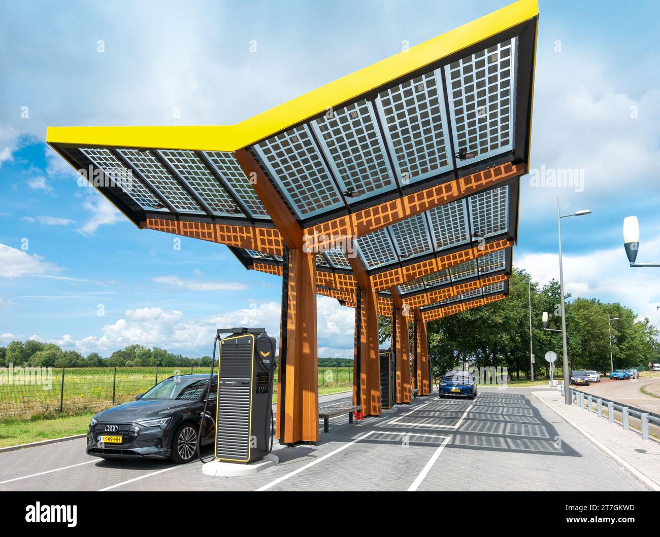 Electric vehicle car charging station point along Highway A2. Fastned fast charger. Solar panels integrated in the roof structure. The Netherlands Stock Photo