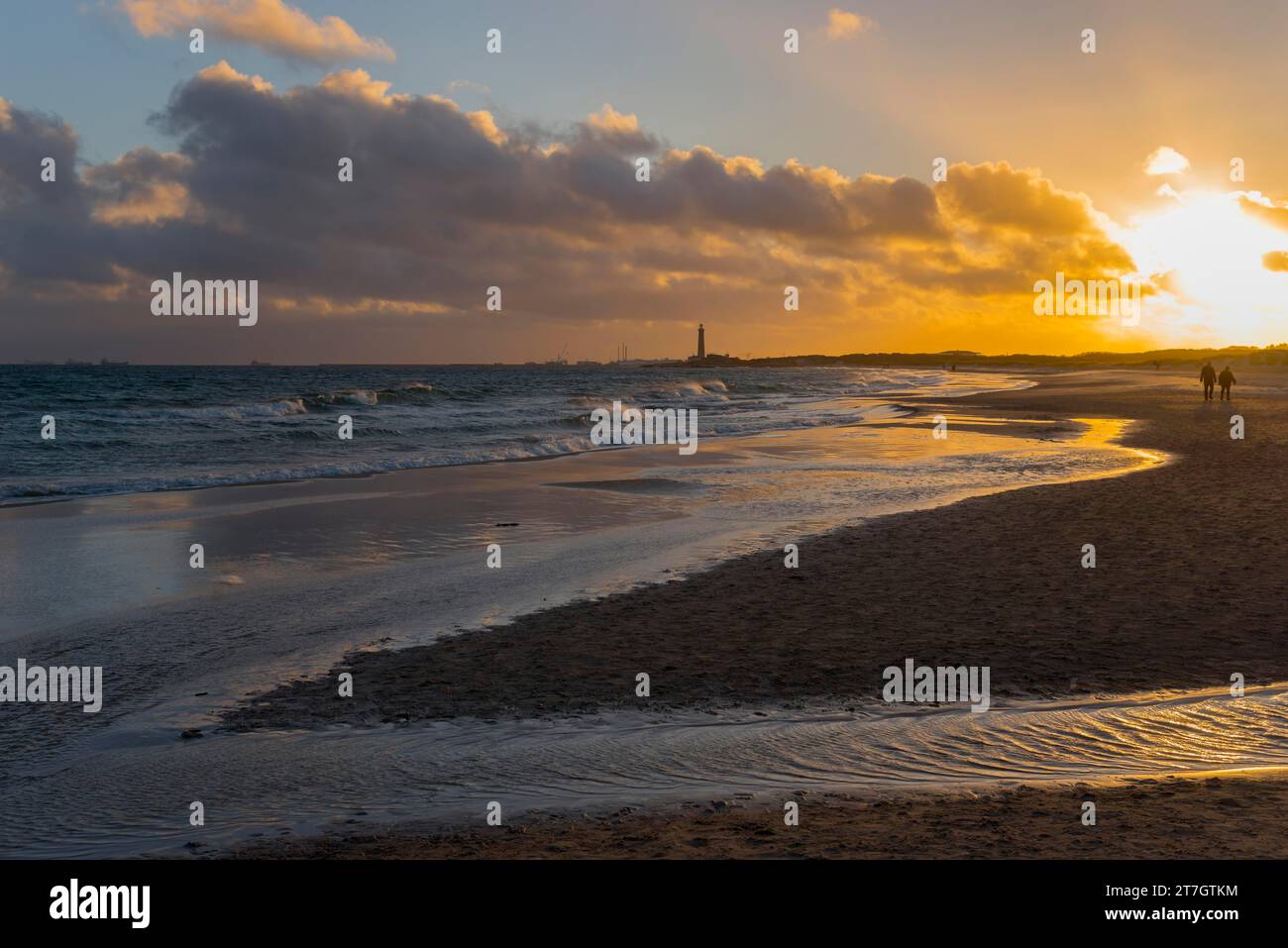 Baltic Sea beach at sunset at the meeting of the North Sea and the Baltic Sea, Skagerrak and Kattegat, view of the grey lighthouse, Grenen, Skagens Stock Photo