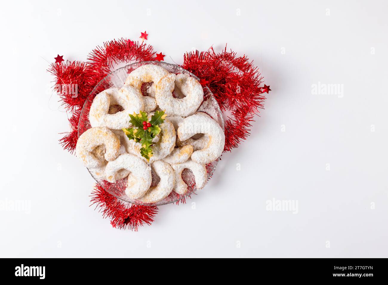 Glass plate with vanilla crescents, Christmas biscuits, Christmas decoration, white background, copy room Stock Photo