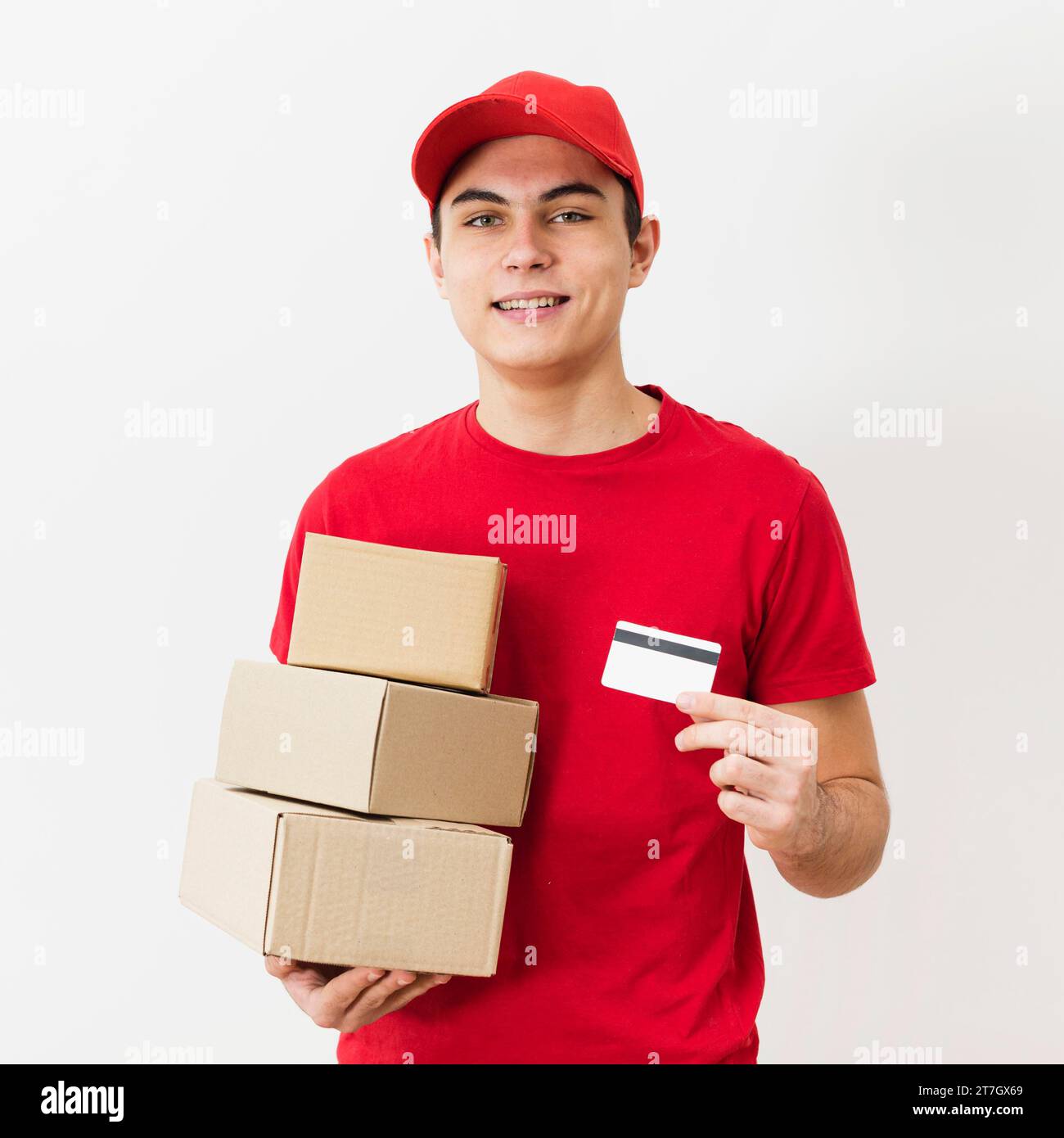 Delivery man with packages credit card Stock Photo - Alamy