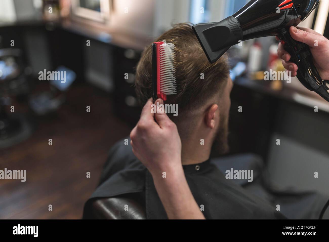 From barber combing drying hair client Stock Photo