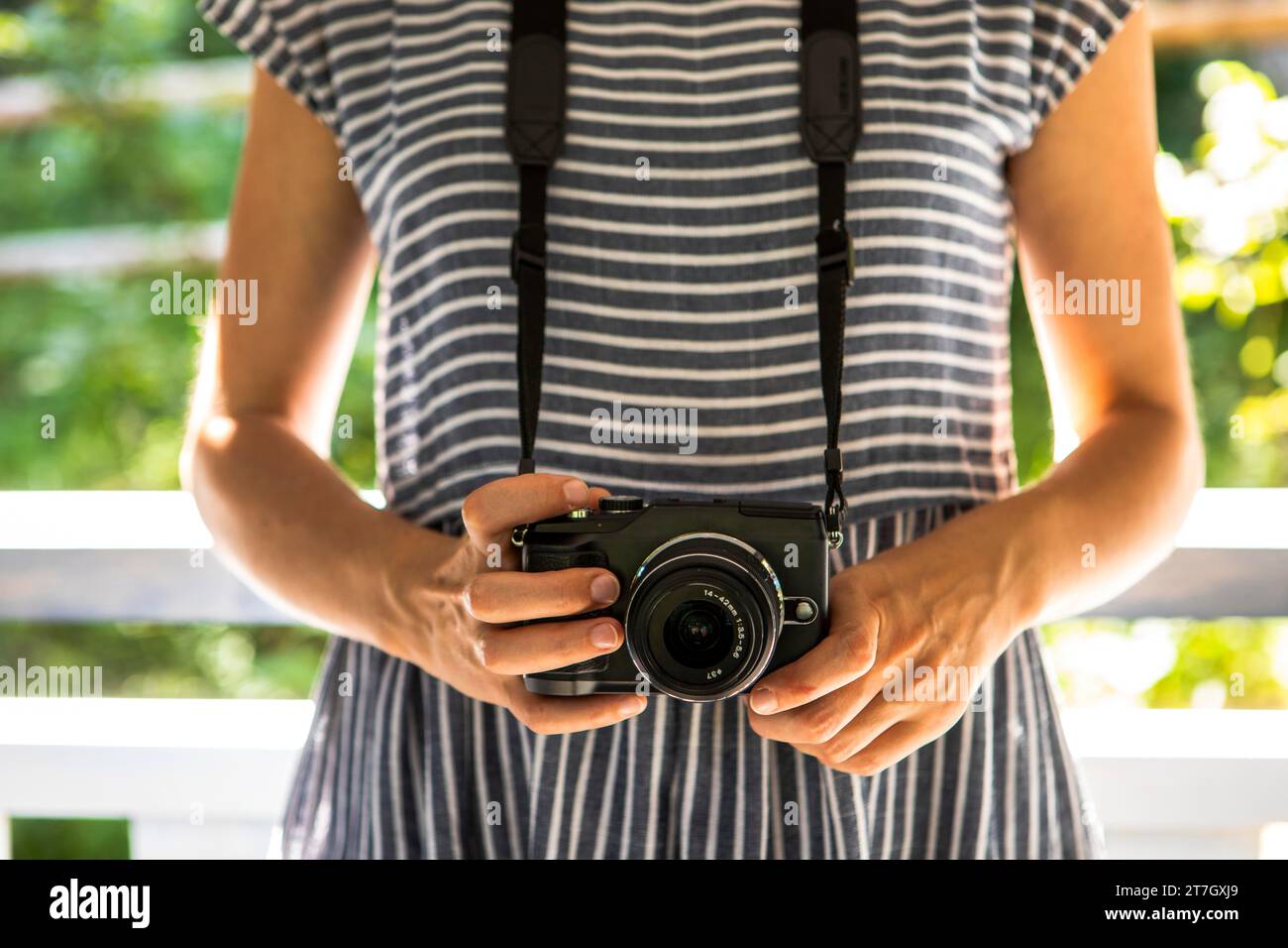 Front view woman with camera Stock Photo
