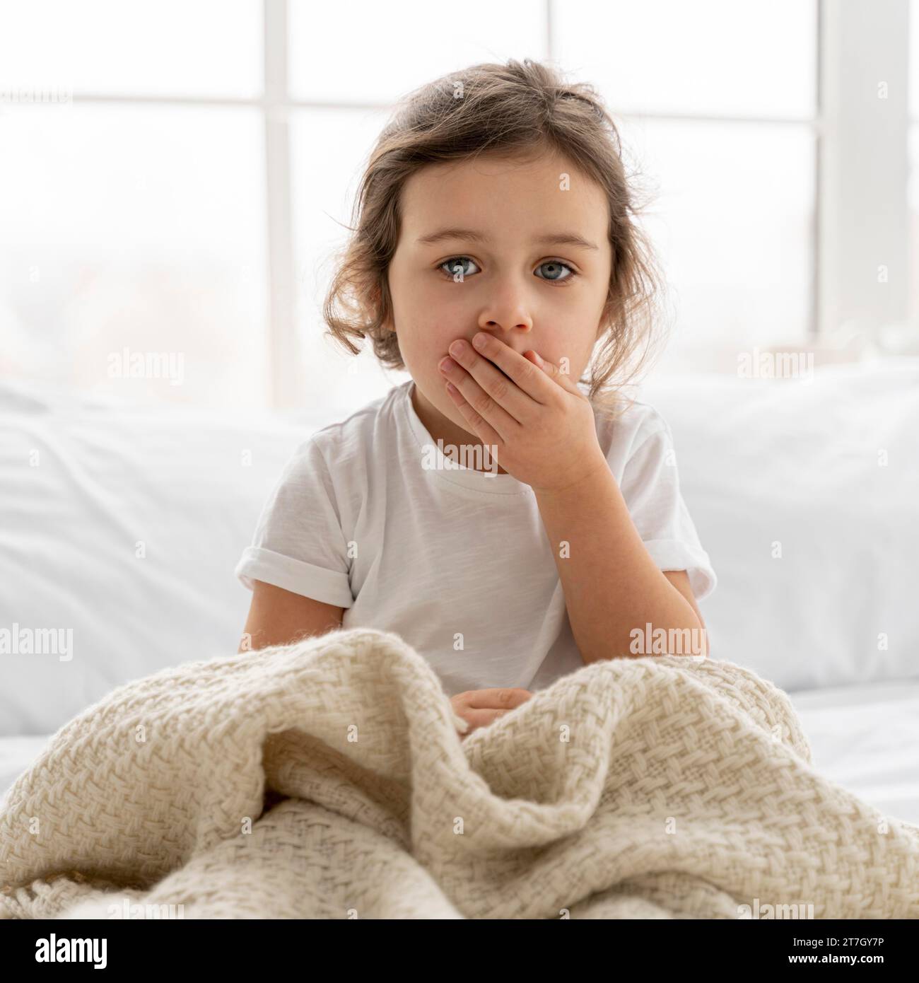 Medium shot kid with blanket Stock Photo