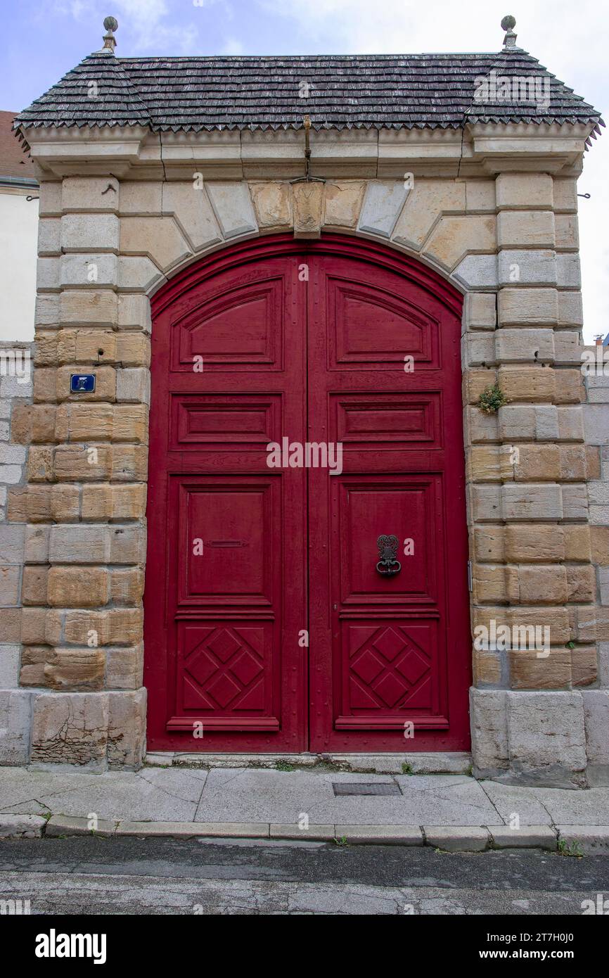 Antique red door on stone walls, Langres old town, Langres, Haute-Marne department, Champagne-Ardennes region, France Stock Photo