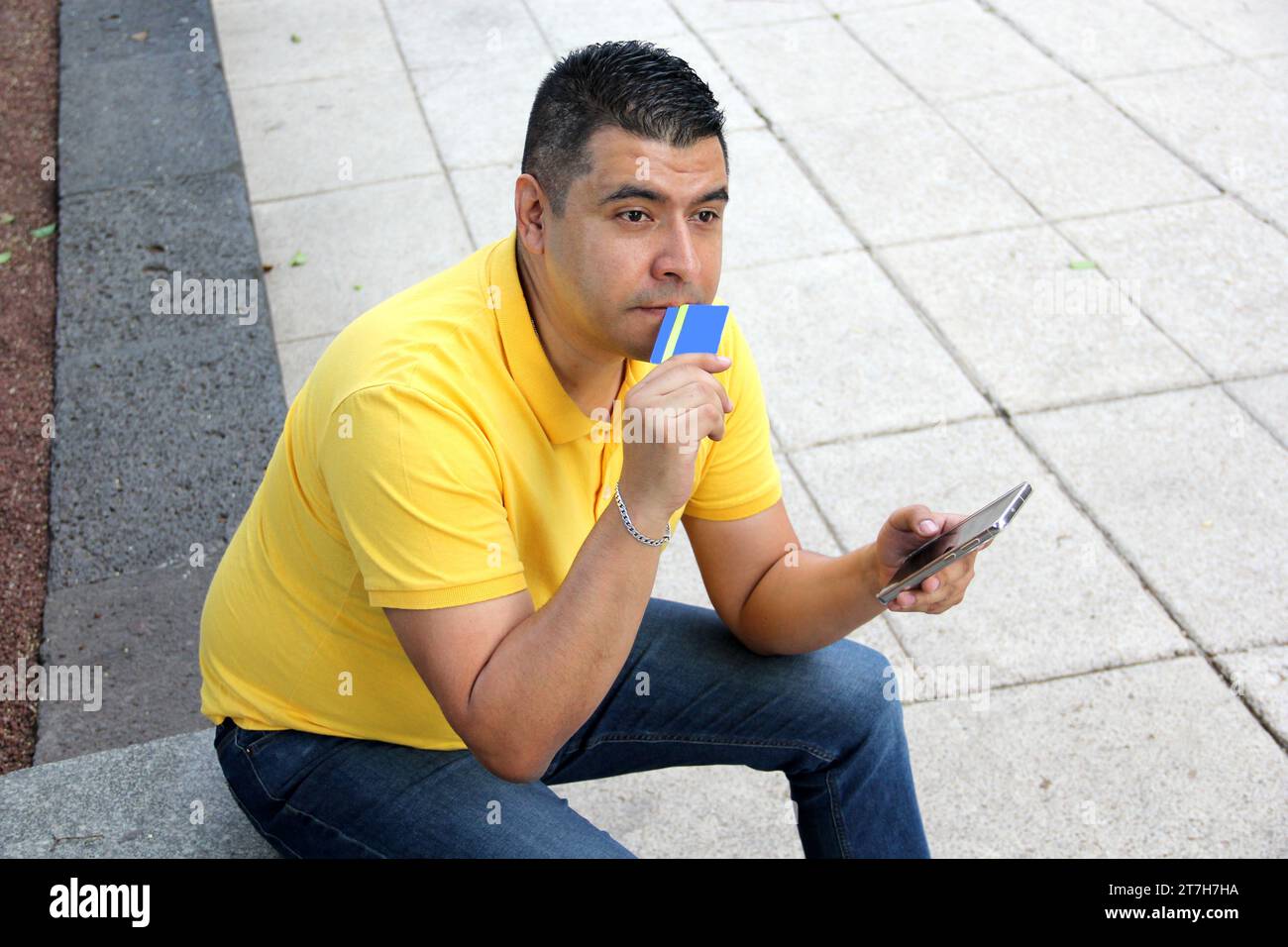 40-year-old dark-skinned Latino man has problems with his credit card and makes a call to customer service Stock Photo