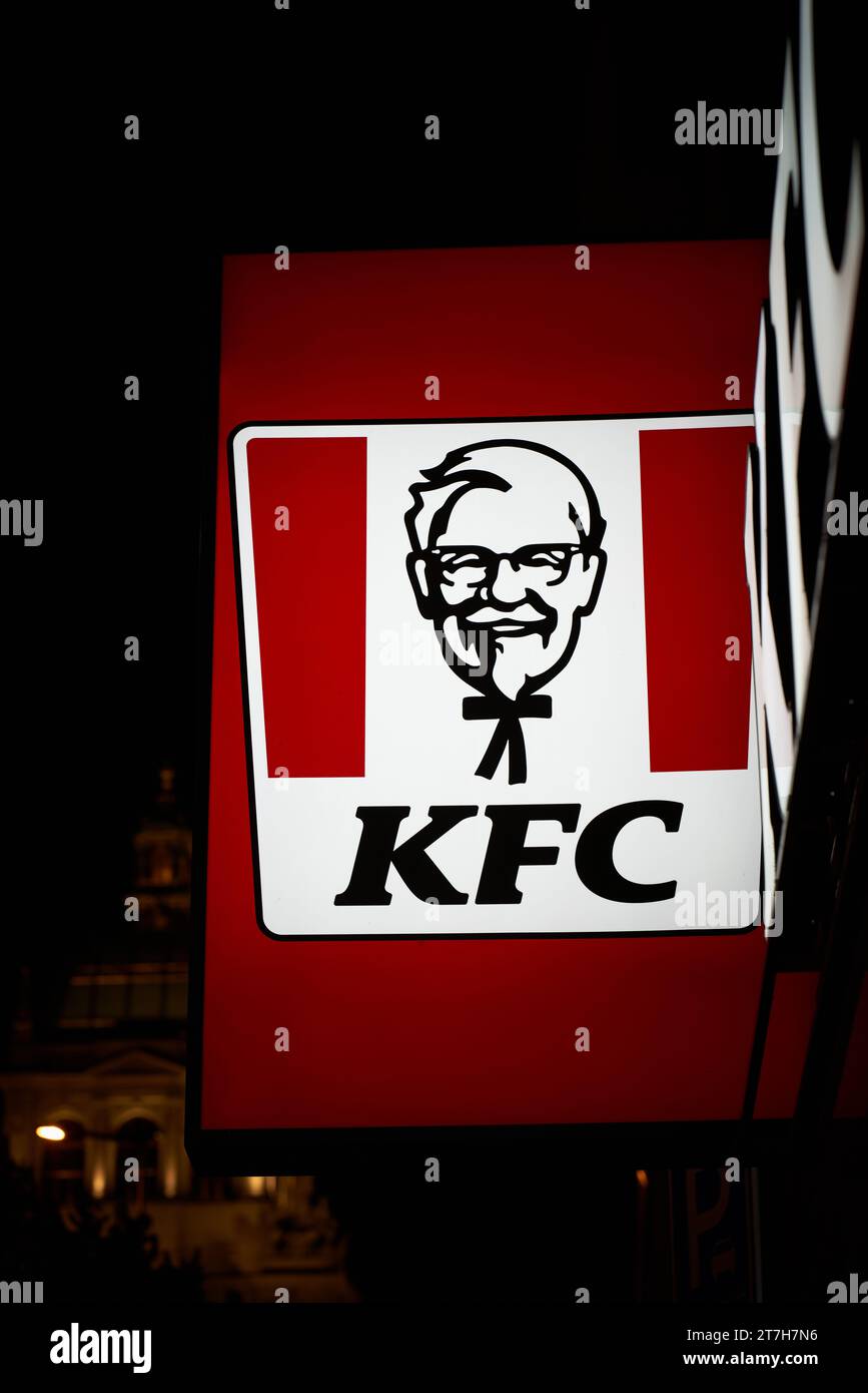 Illuminated sign of the restaurant chain KFC, Kentucky Fried Chicken in the city center of Prague at night Stock Photo