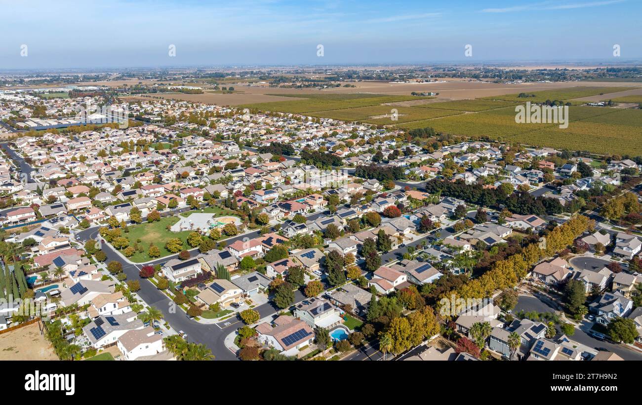 Aerial images over a suburb in Brentwood, California with a blue sky and streets and houses and room for text on the top. Stock Photo