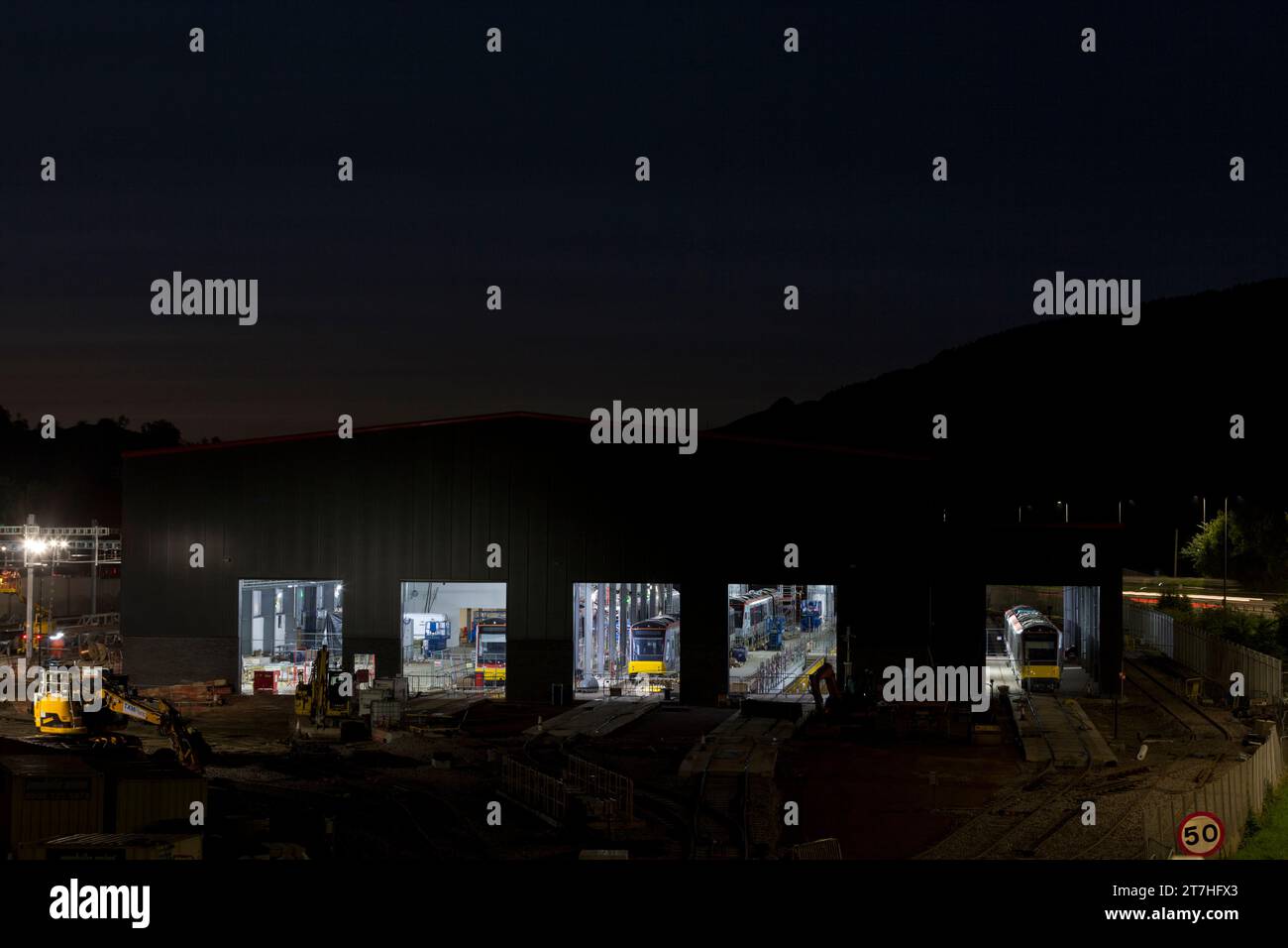 Taff’s Well depot, South Wales, UK  New tram train depot under construction for the south Wales Metro with new Stadler tram trains inside at night. Stock Photo