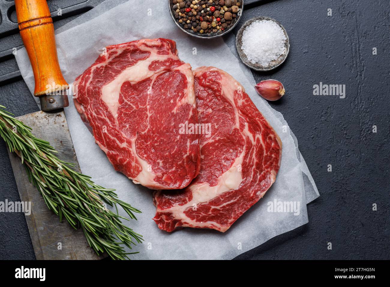 Raw ribeye steaks with savory spices. Flat lay Stock Photo Alamy