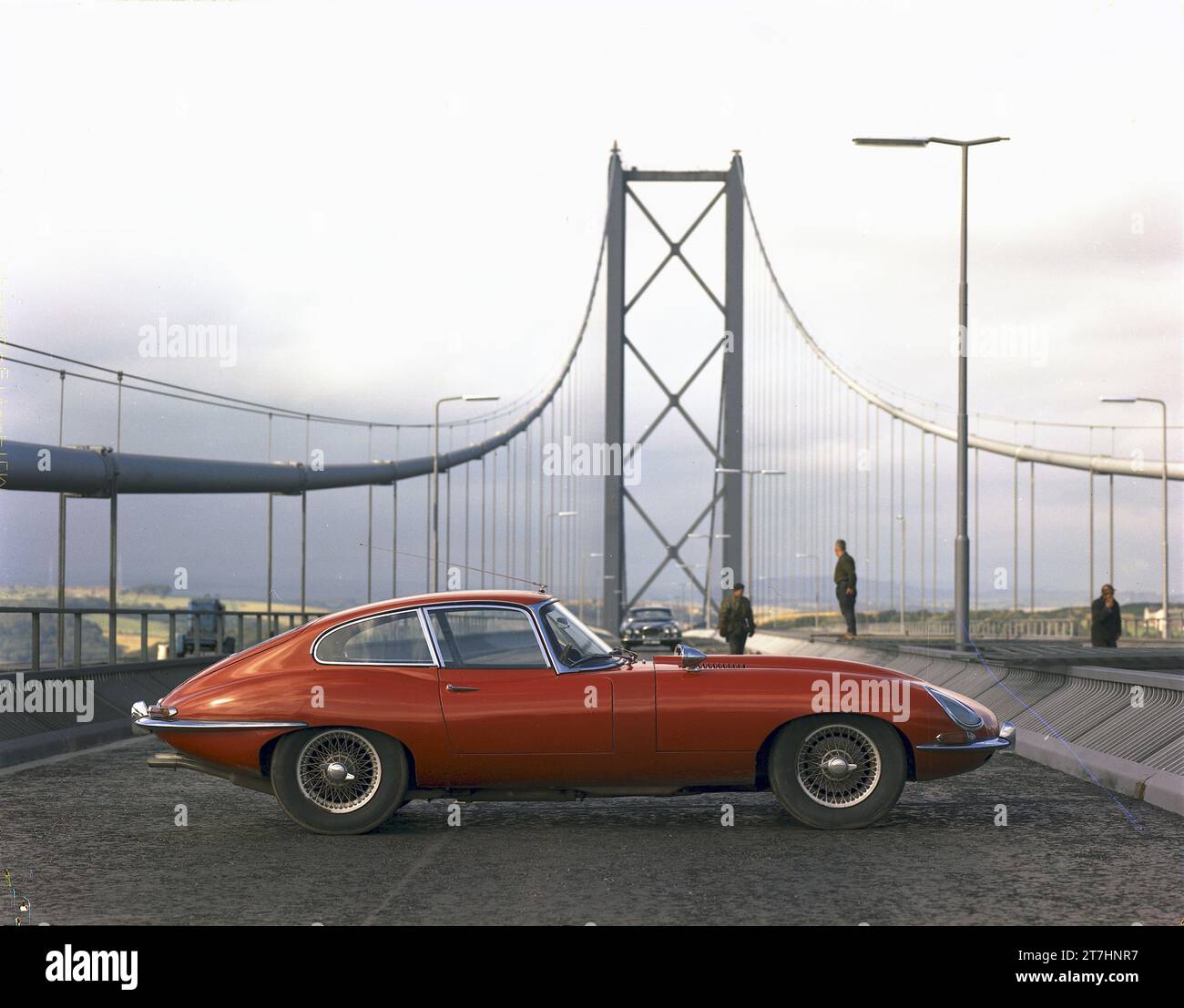 1964 Press picture of red Jaguar E-type Series 1 Coupe, TES 1, parked on the carriageway of the newly opened Forth Road Bridge in Scotland Stock Photo