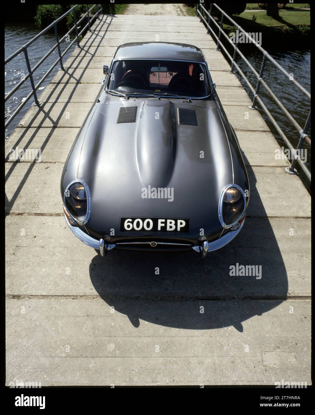 1962 Jaguar E-type Series 1 Coupe 600 FBP, Opalescent Silver Grey parked on a narrow concrete bridge Stock Photo