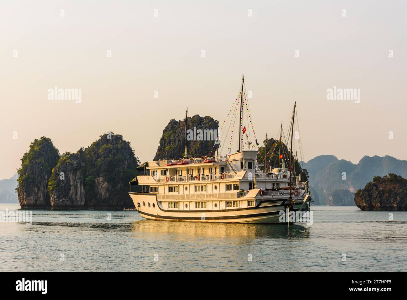 Tourist cruise ship at sunset on Halong Bay, Vietnam Stock Photo