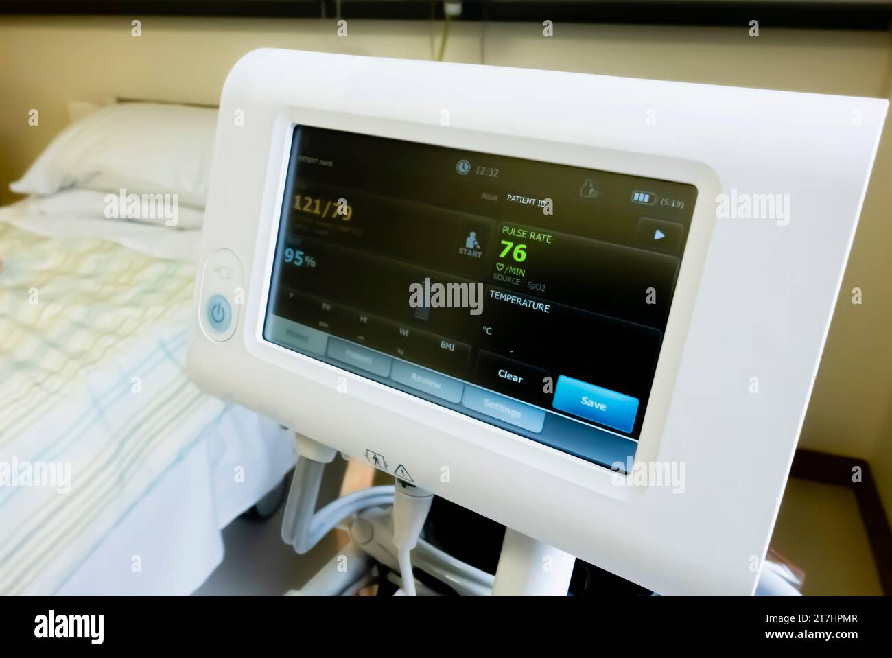 WelchAllyn blood pressure monitor in a hospital ward showing a normal blood pressure of 121/79, and a blood saturation level of 95%. Stock Photo