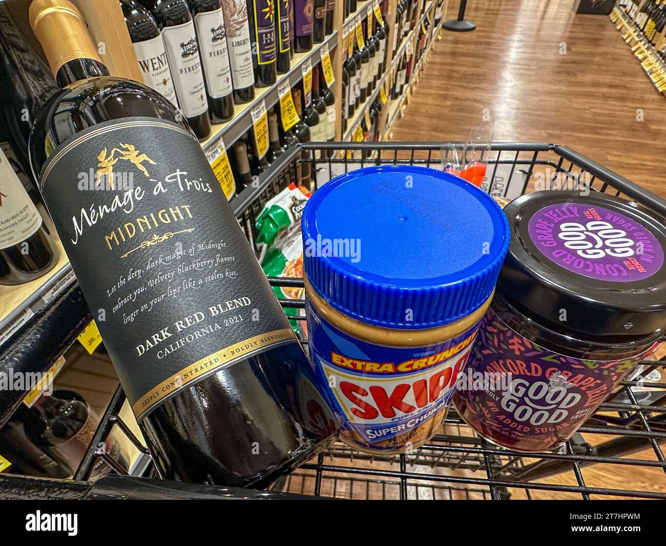 Montecito, California, USA. 13th Nov, 2023. Wine and Peanut butter and jelly at Pavilions grocery store in Montecito. In a cart is Menage a Trois Midnight Dark Red Blend wine, Skippy peanut butter and Good Good Concord grape Jelly (Credit Image: © Amy Katz/ZUMA Press Wire) EDITORIAL USAGE ONLY! Not for Commercial USAGE! Stock Photo