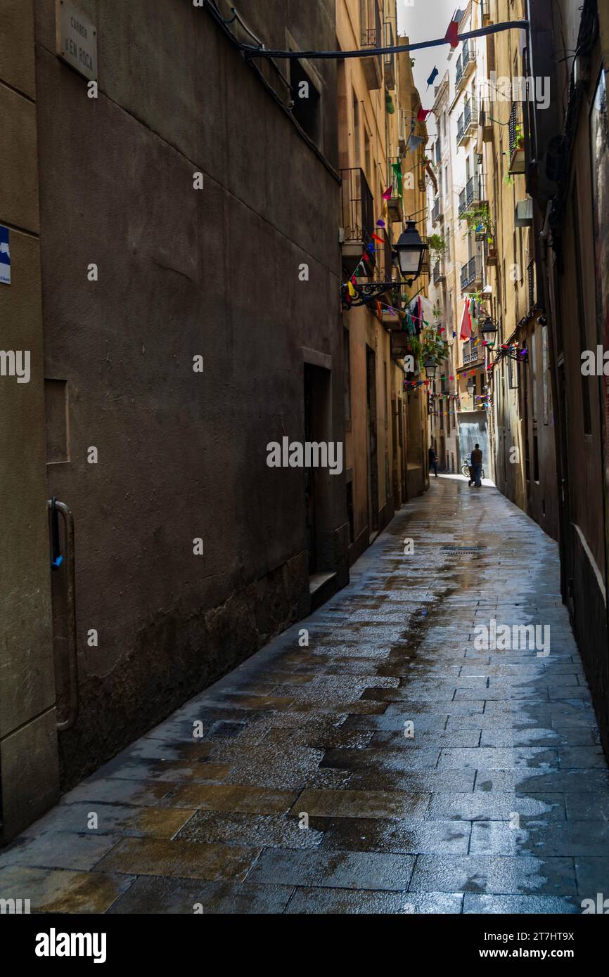 Barcelona, Catalonia, Spain April 30 2017 - Carrer d'En Roca a narrow street in Barcelona with balconeys and old street lighting Stock Photo