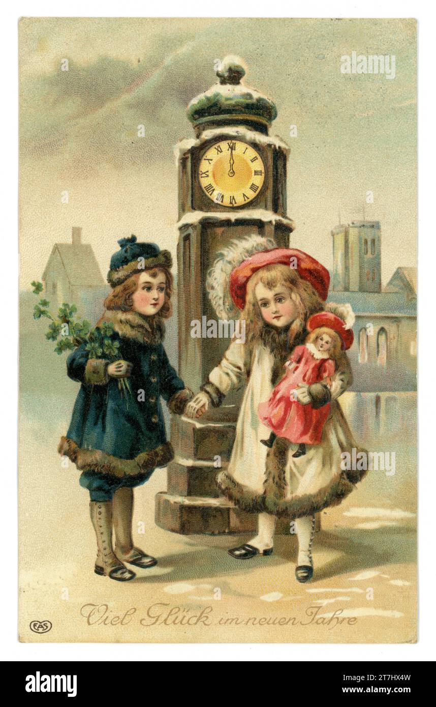 Original, charming, early 1900's German Happy New Year greetings good luck postcard, two cute children, maybe brother and sister, dressed in fur coats and hats meeting under a clock tower at midnight, the boy holds a bouquet of lucky clover, the girl a doll,  posted / dated 1912, Germany, Europe. Stock Photo