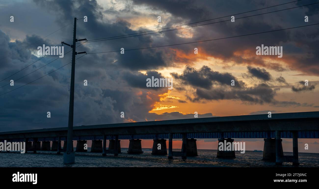 Sunset Silhouette of Bridge Over Sea Stock Photo - Alamy