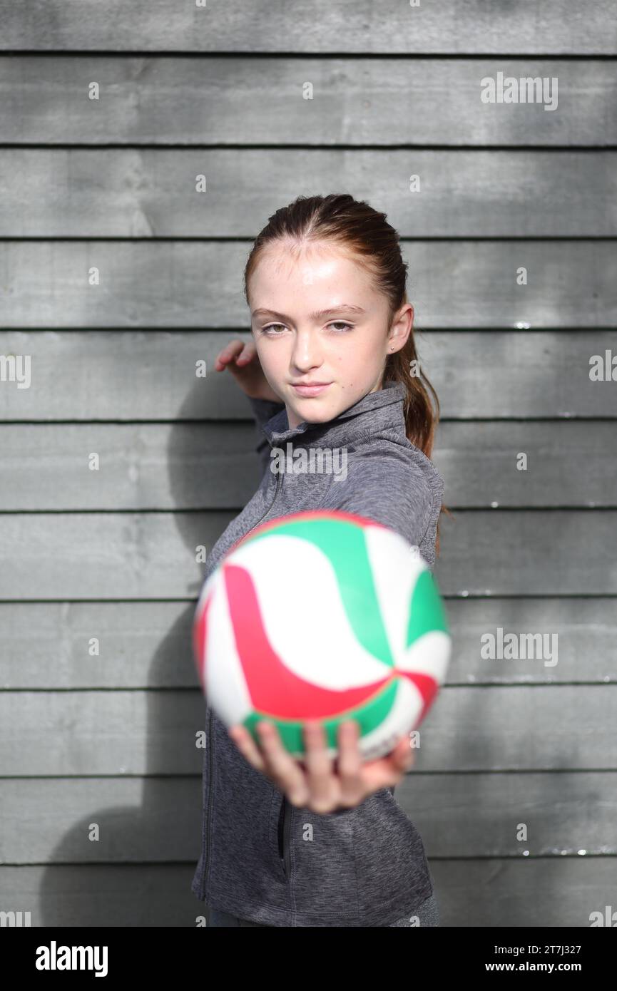Teenage girl practises volleyball shots Stock Photo Alamy