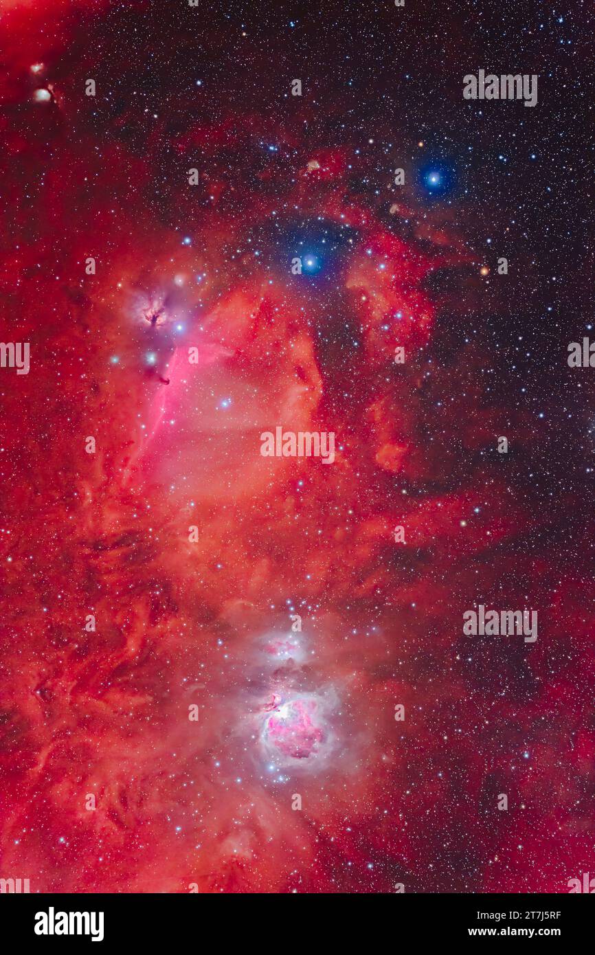 A widefield view of Orion's Belt and Sword showing the complex of nebulosity in the area. The three Belt stars are at top (L to R): Alnitak, Alnilam a Stock Photo