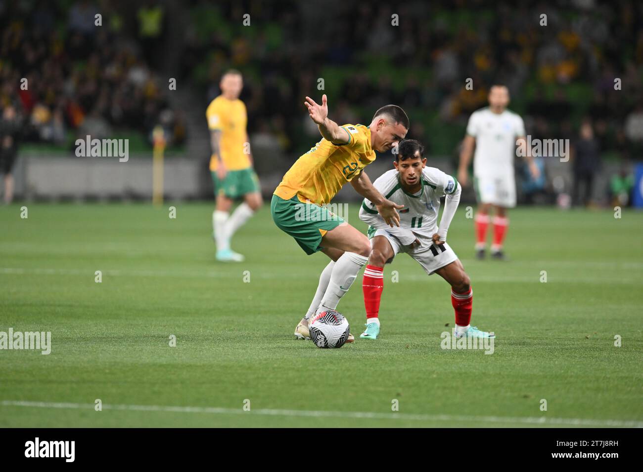 MELBOURNE, AUSTRALIA 16th November 2023. Pictured: Australian defender Lewis Miller(20) (left) takes on Bangladesh forward Foysal Ahmed Fahim (11) (right) at the FIFA World Cup 2026 AFC Asian Qualifiers R1 Australia v Bangladesh at Melbourne’s rectangular stadium. Credit: Karl Phillipson/Alamy Live News Stock Photo