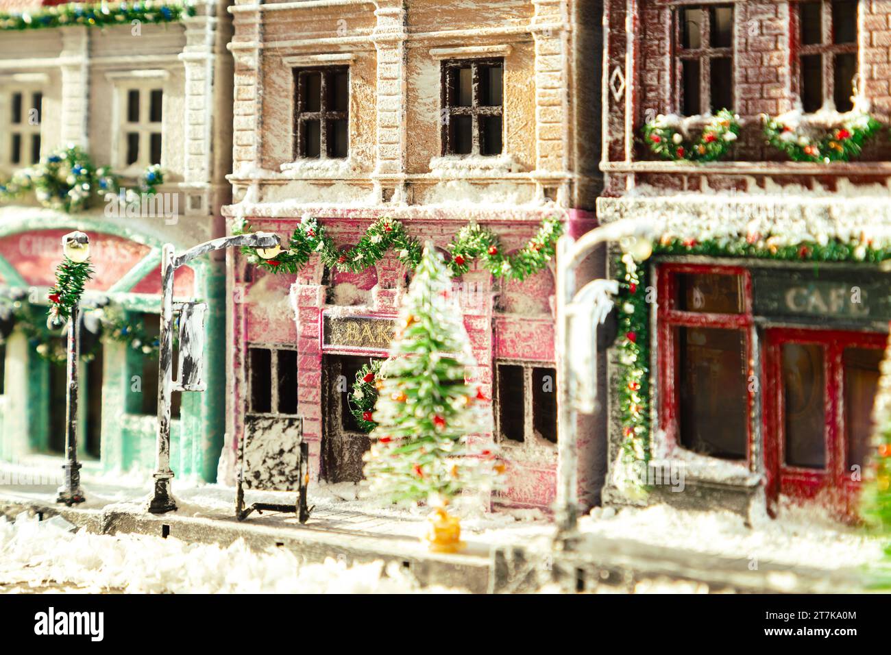 Winter snowy European street decorated for Christmas. Homemade decorated toy houses. All elements of the image are made and drawn by hand. Selective f Stock Photo