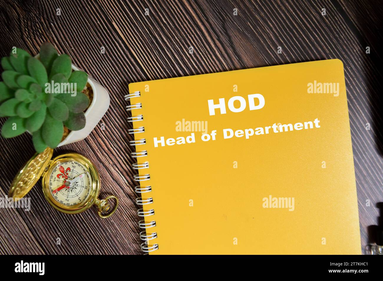 Concept of HOD - Head of Department write on book isolated on Wooden Table. Stock Photo