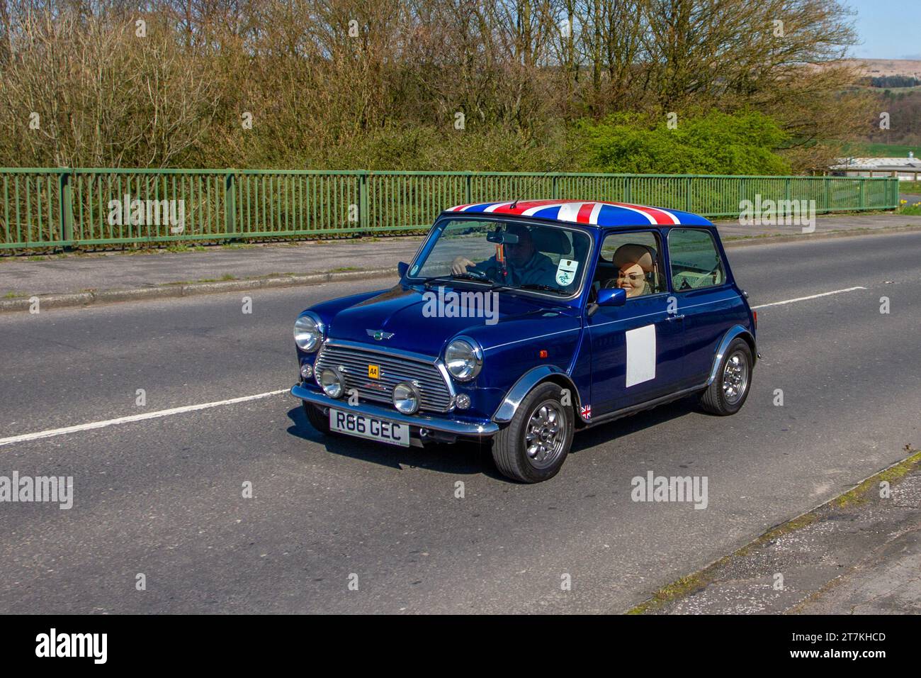 1997 90s nineties Blue Rover Mini with Union Jack roof cap, with mask attached to passenger seat headrest; Stock Photo