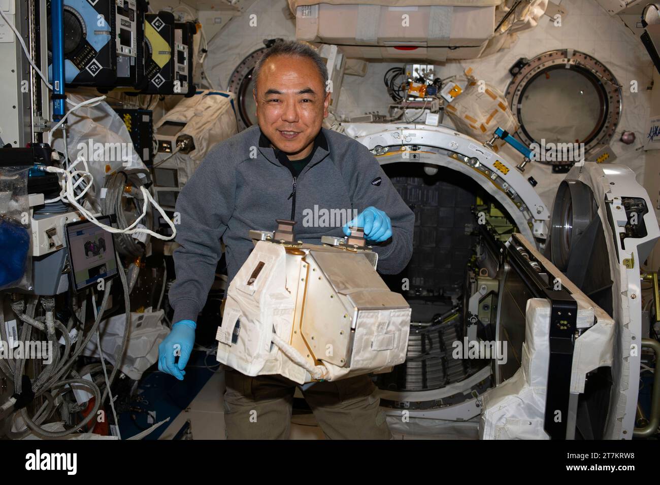 ISS - 27 October 2023 - JAXA (Japan Aerospace Exploration Agency) astronaut and Expedition 70 Flight Engineer Satoshi Furukawa removes hardware from i Stock Photo
