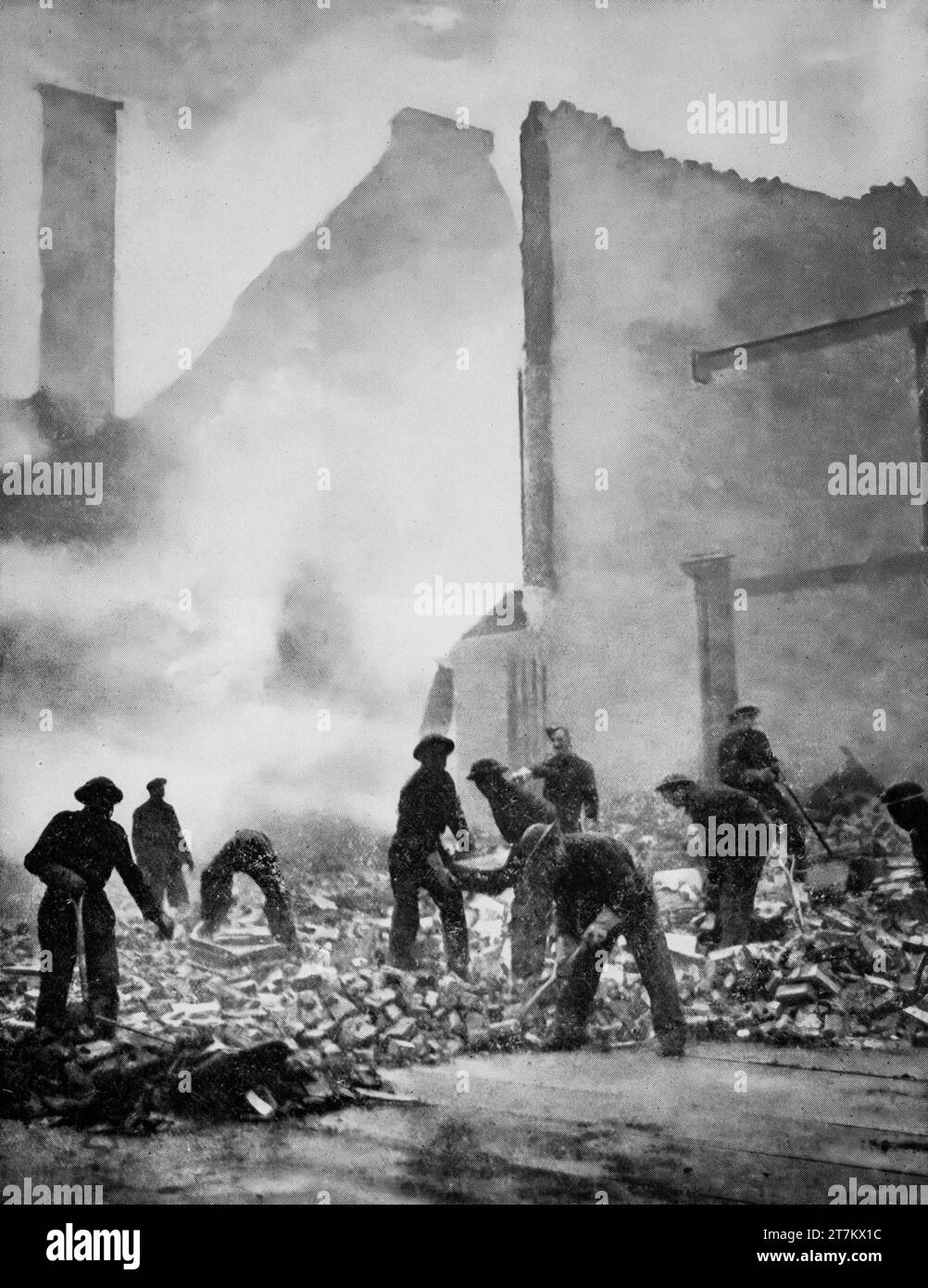 Members of the Pioneer Corps clearing rubble and damage to London streets following Luftwaffe air raids during the Second World War in January 1941. Stock Photo