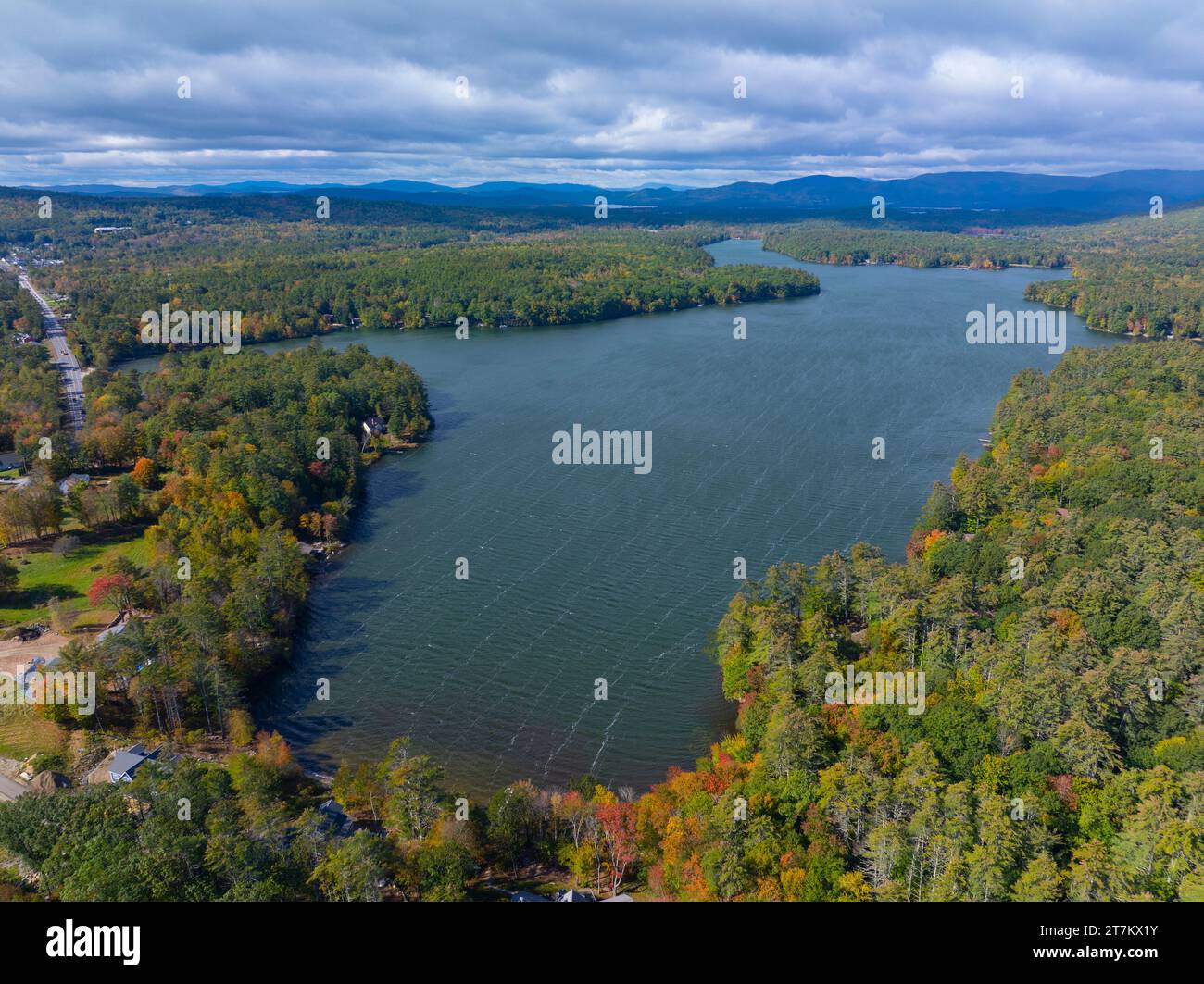 Lake Kanasatka near Lake Winnipesaukee with sunshine through clouds in